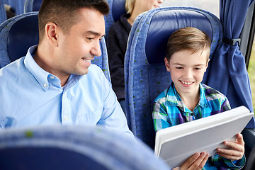 Image showing happy family with tablet pc sitting in travel bus