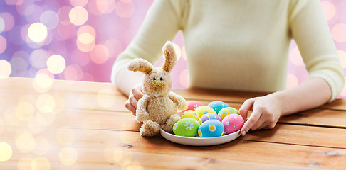 Image showing close up of woman hands with easter eggs and bunny