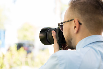 Image showing close up of male photographer with digital camera