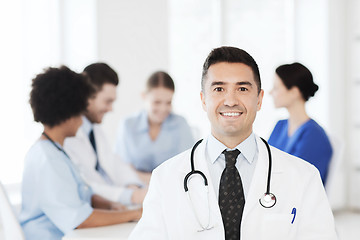 Image showing happy doctor over group of medics at hospital