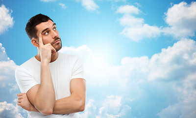 Image showing man thinking over blue sky