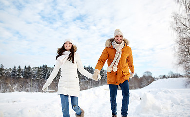 Image showing happy couple running in winter snow