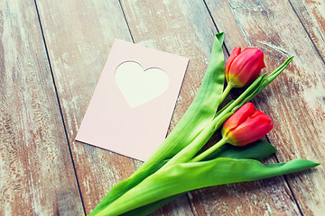 Image showing close up of tulips and greeting card with heart