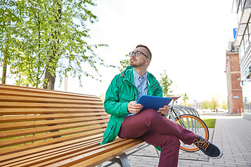 Image showing happy young hipster man with tablet pc and bike