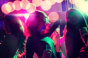 Image showing smiling friends with glasses of champagne in club