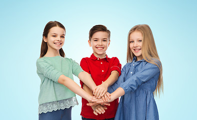 Image showing happy boy and girls with hands on top