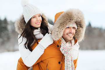 Image showing happy couple having fun over winter background