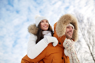 Image showing happy couple having fun over winter background