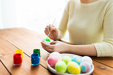 Image showing close up of woman hands coloring easter eggs