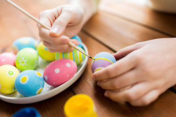 Image showing close up of woman hands coloring easter eggs