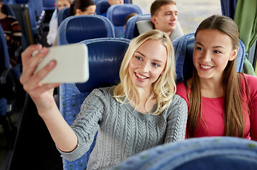 Image showing women taking selfie by smartphone in travel bus