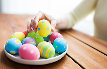 Image showing close up of woman hands with colored easter eggs