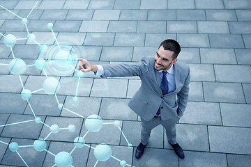 Image showing young smiling businessman outdoors from top