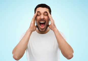 Image showing crazy shouting man in t-shirt over blue background