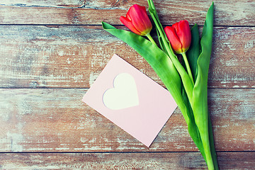 Image showing close up of tulips and greeting card with heart