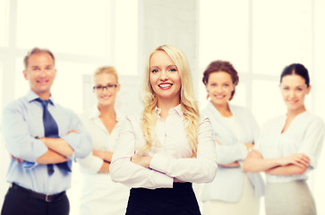 Image showing smiling businesswoman or secretary in office