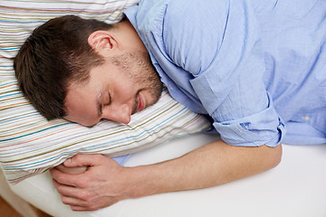 Image showing close up of  happy young man sleeping at home