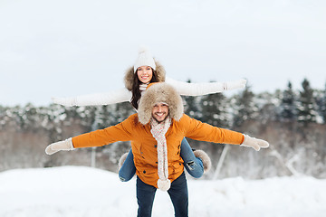 Image showing happy couple having fun over winter background