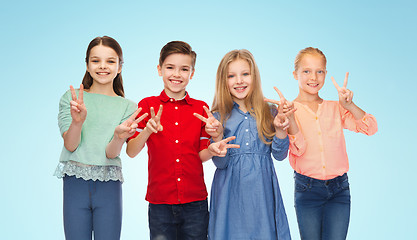 Image showing happy boy and girls showing peace hand sign
