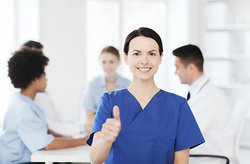 Image showing happy doctor over group of medics at hospital