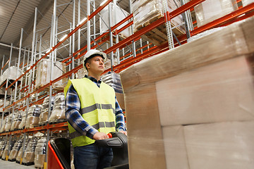 Image showing man on forklift loading cargo at warehouse