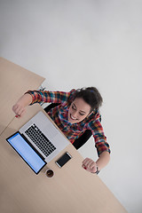 Image showing top view of young business woman working on laptop