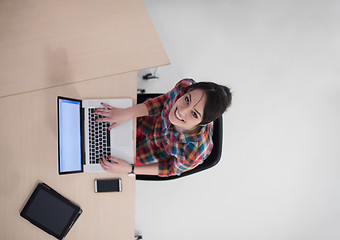 Image showing top view of young business woman working on laptop