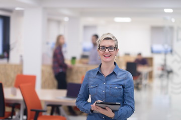 Image showing portrait of young business woman at office with team in backgrou