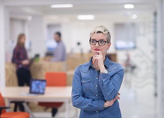 Image showing portrait of young business woman at office with team in backgrou