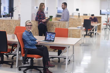 Image showing portrait of young business woman at office with team in backgrou