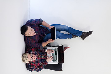 Image showing top view of  couple working on laptop computer at startup office