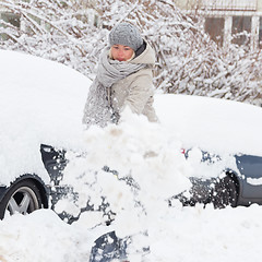 Image showing Independent woman shoveling snow in winter.