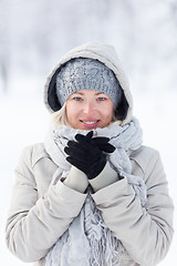 Image showing Girl beeing cold outdoors in winter.