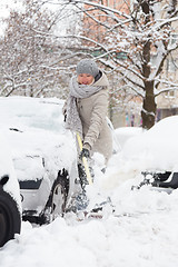 Image showing Independent woman shoveling snow in winter.