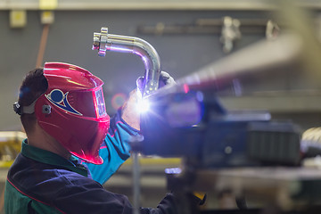 Image showing Industrial worker welding in metal factory.