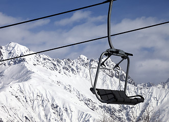 Image showing Chair lift in snowy mountains at nice sunny day