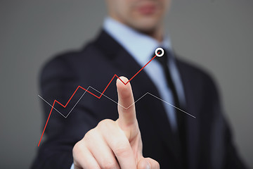 Image showing Businessman Touching a Graph Indicating Growth