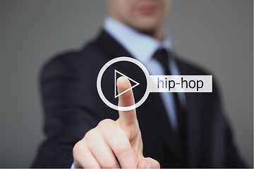 Image showing Businessman pressing play hip hop music button 