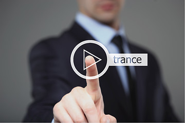 Image showing Businessman pressing play trance music button 