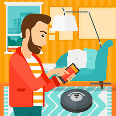 Image showing Man with robot vacuum cleaner.