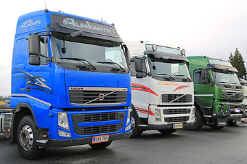 Image showing Three Colorful Volvo Trucks