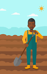 Image showing Farmer on the field with shovel.