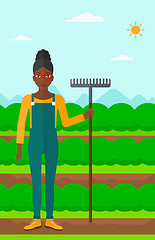 Image showing Farmer with rake.