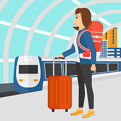 Image showing Woman with suitcase on wheels and briefcase.