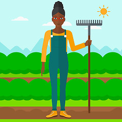 Image showing Farmer with rake.