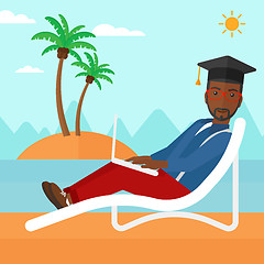 Image showing Graduate lying on chaise lounge with laptop.