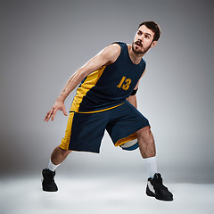 Image showing Full length portrait of a basketball player with ball 