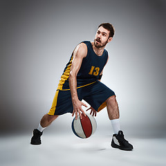 Image showing Full length portrait of a basketball player with ball 