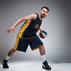 Image showing Full length portrait of a basketball player with ball 