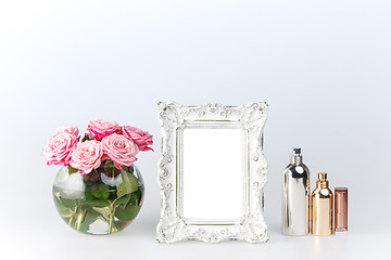 Image showing Flowers vase and vintage frame on white